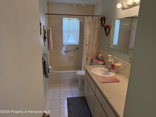 bathroom with tile patterned floors, toilet, vanity, and shower / tub combo with curtain