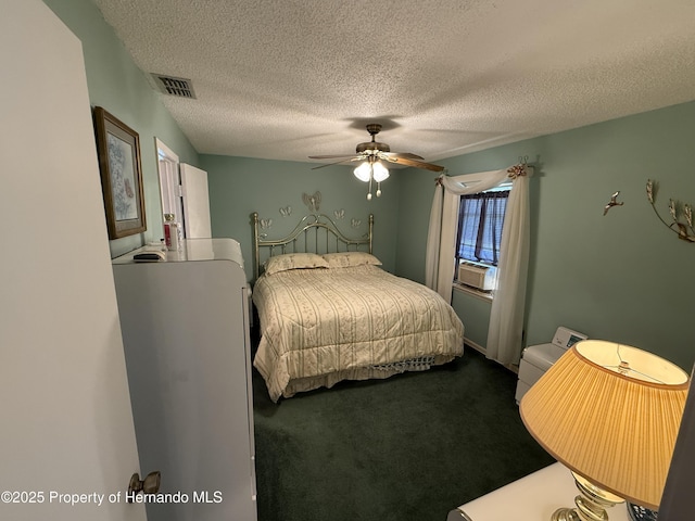 bedroom with dark colored carpet, visible vents, a textured ceiling, and ceiling fan