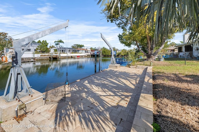 dock area featuring a water view and fence