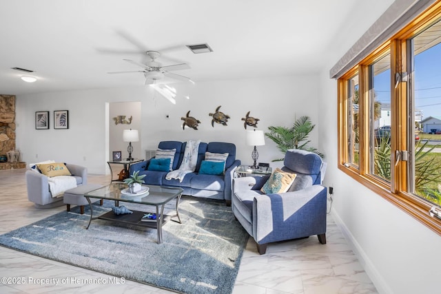 living room featuring visible vents, baseboards, marble finish floor, and a ceiling fan