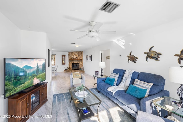 living room featuring a fireplace, a ceiling fan, visible vents, and marble finish floor