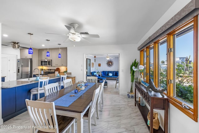 dining area featuring baseboards, visible vents, marble finish floor, and ceiling fan