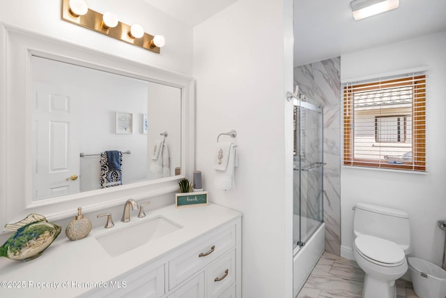 full bath featuring enclosed tub / shower combo, marble finish floor, toilet, and vanity