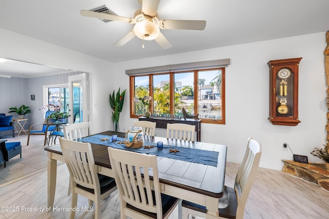 dining area featuring marble finish floor, baseboards, and ceiling fan