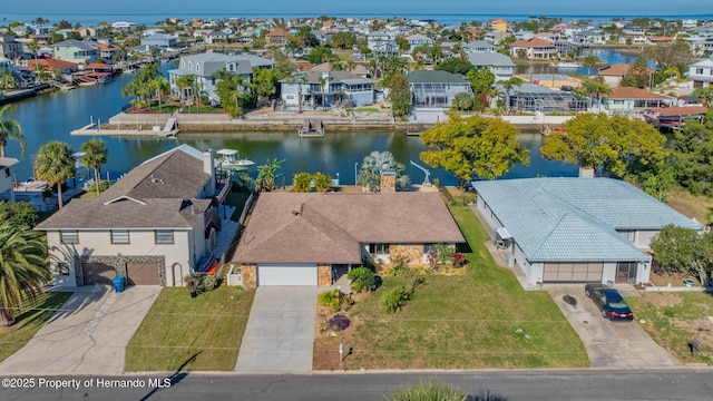 birds eye view of property with a residential view and a water view