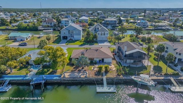 bird's eye view with a residential view and a water view