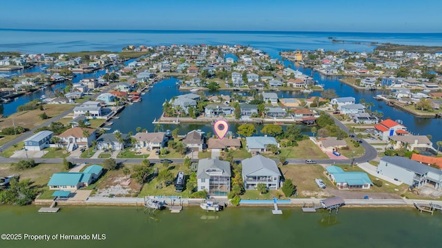 drone / aerial view with a water view and a residential view