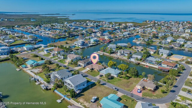 drone / aerial view featuring a water view and a residential view