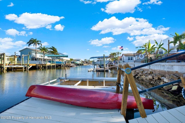 view of dock with boat lift and a water view