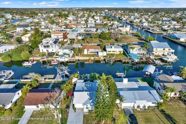 drone / aerial view with a residential view and a water view