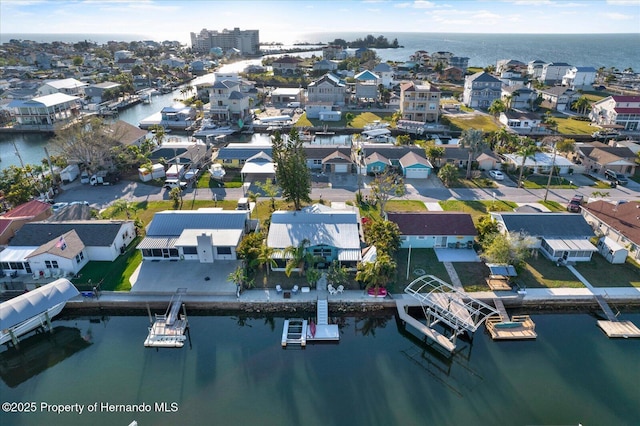 birds eye view of property with a residential view and a water view