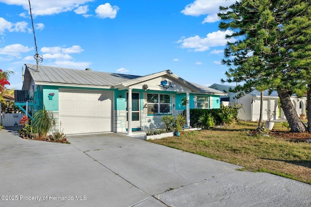 ranch-style house with concrete driveway, a garage, and a front yard