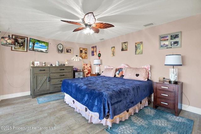 bedroom with visible vents, baseboards, light wood-type flooring, and ceiling fan