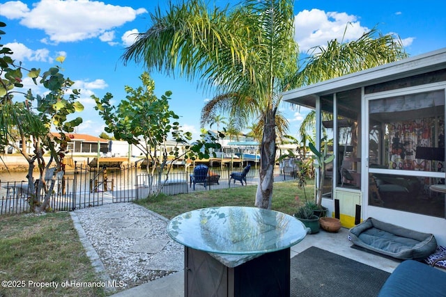 view of patio / terrace with a sunroom and fence