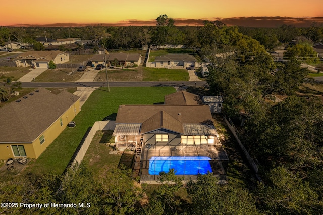 aerial view at dusk featuring a residential view