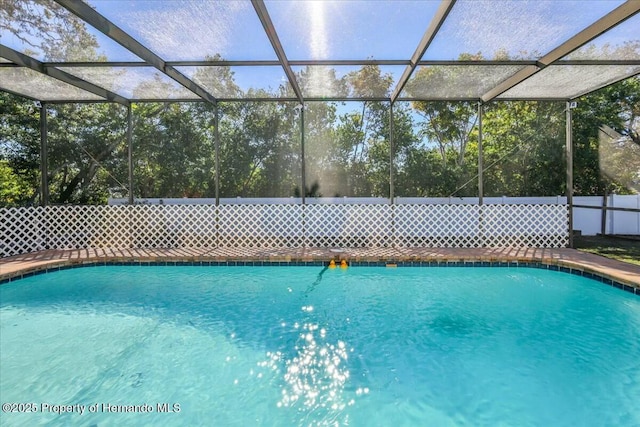 view of swimming pool featuring a lanai and a fenced in pool