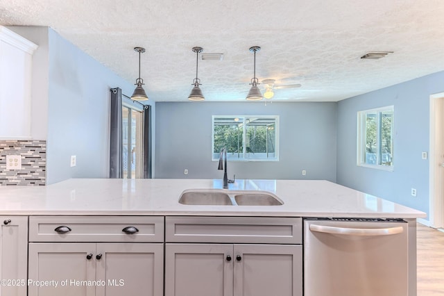 kitchen with a sink, decorative backsplash, dishwasher, and decorative light fixtures
