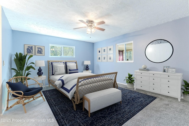 bedroom with baseboards, light colored carpet, a ceiling fan, and a textured ceiling