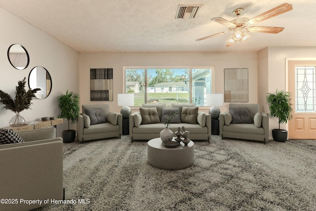 living area featuring carpet, visible vents, and a textured ceiling
