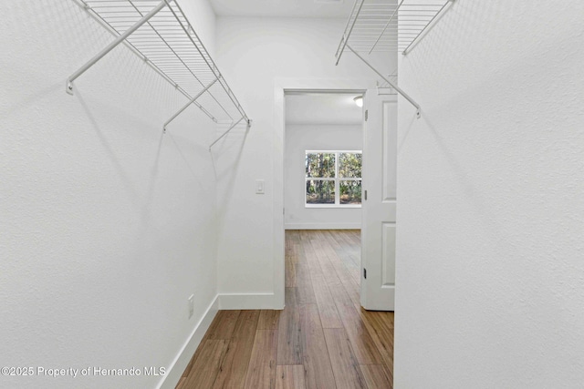 spacious closet with wood finished floors