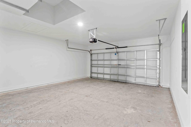 garage with a garage door opener and baseboards