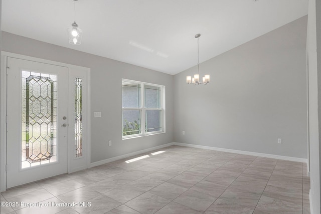 foyer featuring vaulted ceiling, a notable chandelier, and baseboards