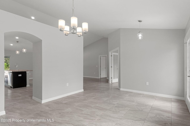 spare room featuring recessed lighting, arched walkways, an inviting chandelier, baseboards, and vaulted ceiling