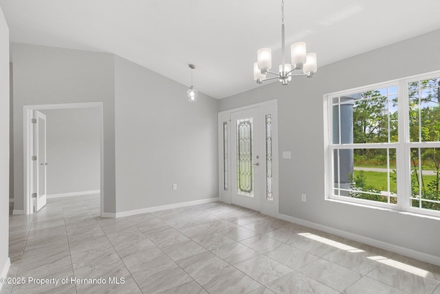 entryway featuring vaulted ceiling, baseboards, and a chandelier