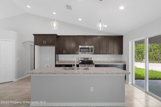 kitchen with visible vents, a sink, decorative light fixtures, stainless steel appliances, and dark brown cabinets