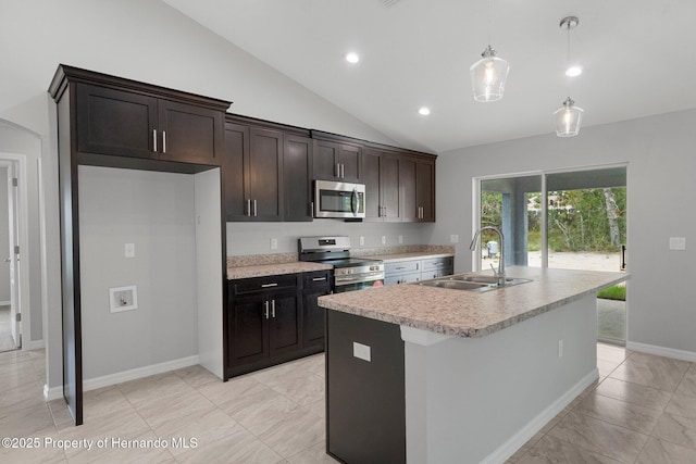 kitchen with a kitchen island with sink, a sink, stainless steel appliances, light countertops, and hanging light fixtures