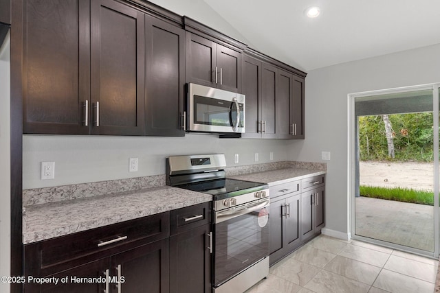 kitchen with stainless steel appliances, lofted ceiling, dark brown cabinets, and light countertops