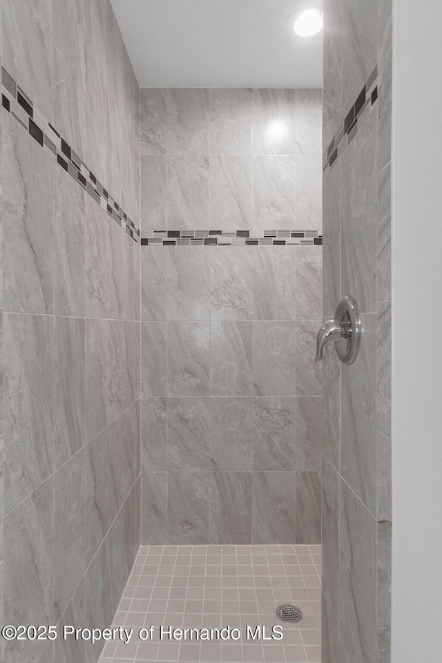 bathroom with a tile shower