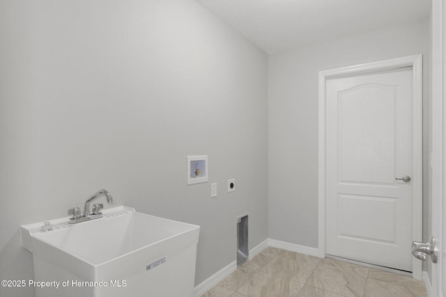 washroom featuring baseboards, washer hookup, laundry area, hookup for an electric dryer, and a sink