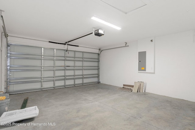 garage featuring electric panel and a garage door opener