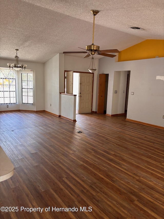 13935 Linden Dr, Spring Hill, FL 34609 - unfurnished living room with a textured ceiling, vaulted ceiling, wood finished floors, baseboards, and ceiling fan with notable chandelier