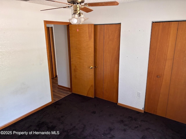 13935 Linden Dr, Spring Hill, FL 34609 - unfurnished bedroom featuring baseboards, carpet flooring, ceiling fan, and two closets