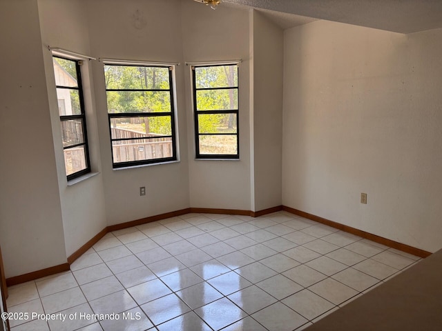 13935 Linden Dr, Spring Hill, FL 34609 - empty room featuring light tile patterned flooring and baseboards