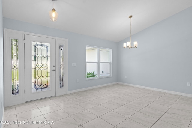 entrance foyer with lofted ceiling, a notable chandelier, and baseboards