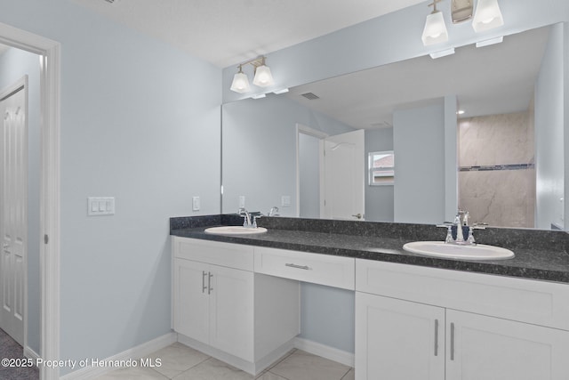 bathroom featuring a sink, visible vents, baseboards, and double vanity