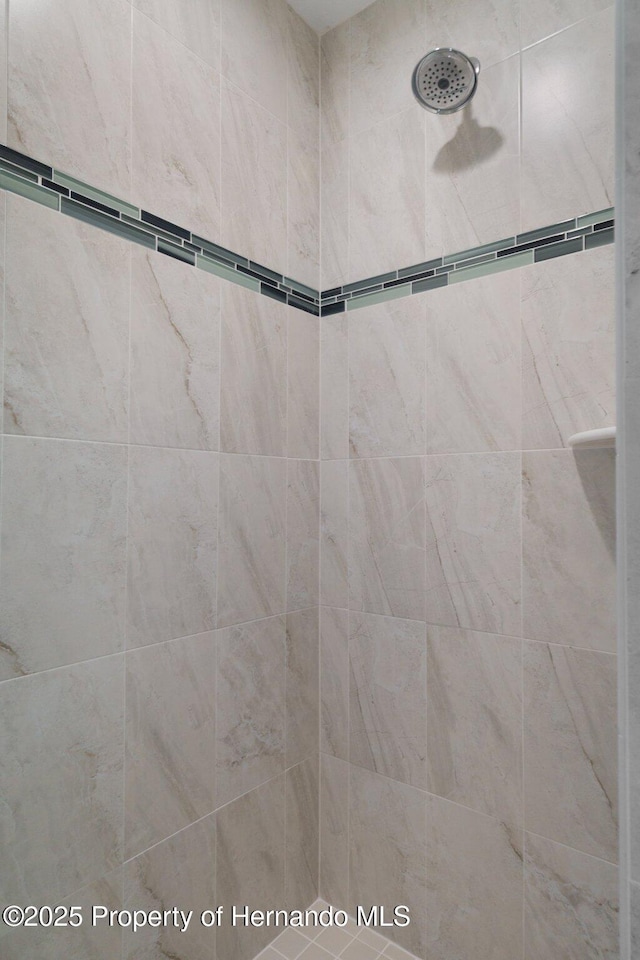 bathroom with a tile shower