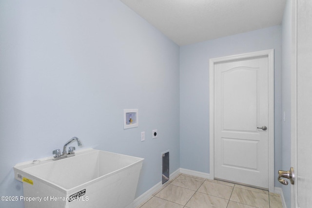 laundry room with baseboards, washer hookup, laundry area, electric dryer hookup, and a sink