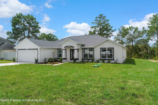 ranch-style house with stucco siding, an attached garage, driveway, and a front yard