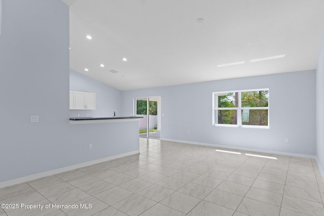 spare room featuring plenty of natural light, recessed lighting, and baseboards