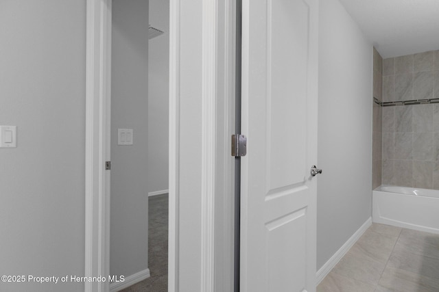 full bath featuring tile patterned floors, baseboards, and shower / tub combination