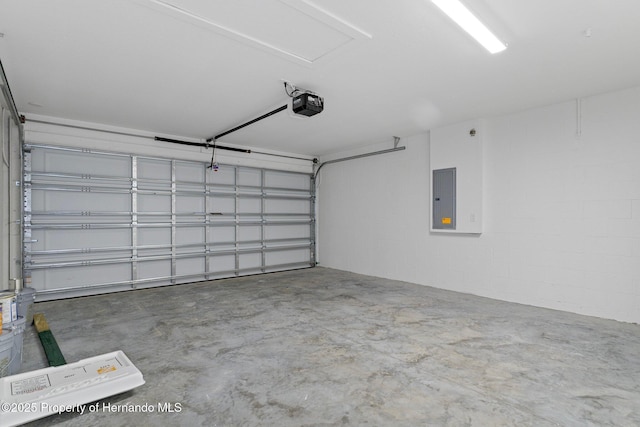 garage with electric panel and a garage door opener