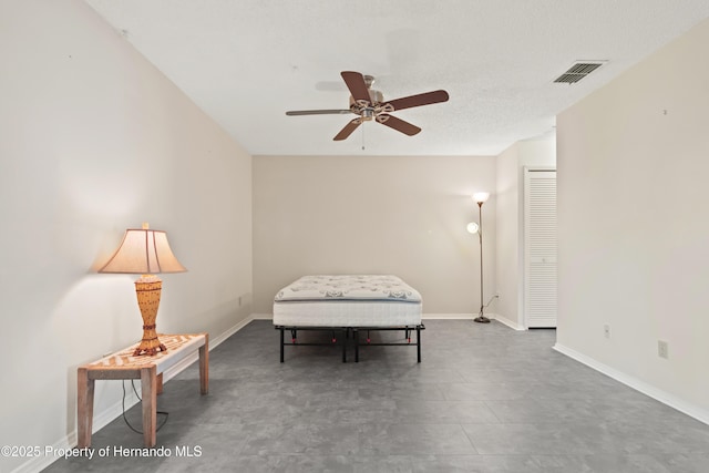 unfurnished room featuring visible vents, baseboards, and ceiling fan