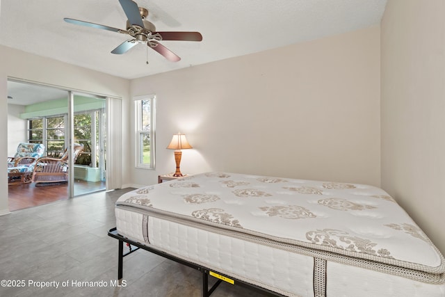 bedroom with a ceiling fan, wood finished floors, and a closet