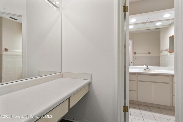 bathroom with tile patterned floors, recessed lighting, and vanity