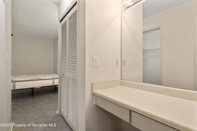 bathroom featuring a closet and a textured ceiling