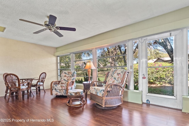 sunroom / solarium featuring visible vents and a ceiling fan